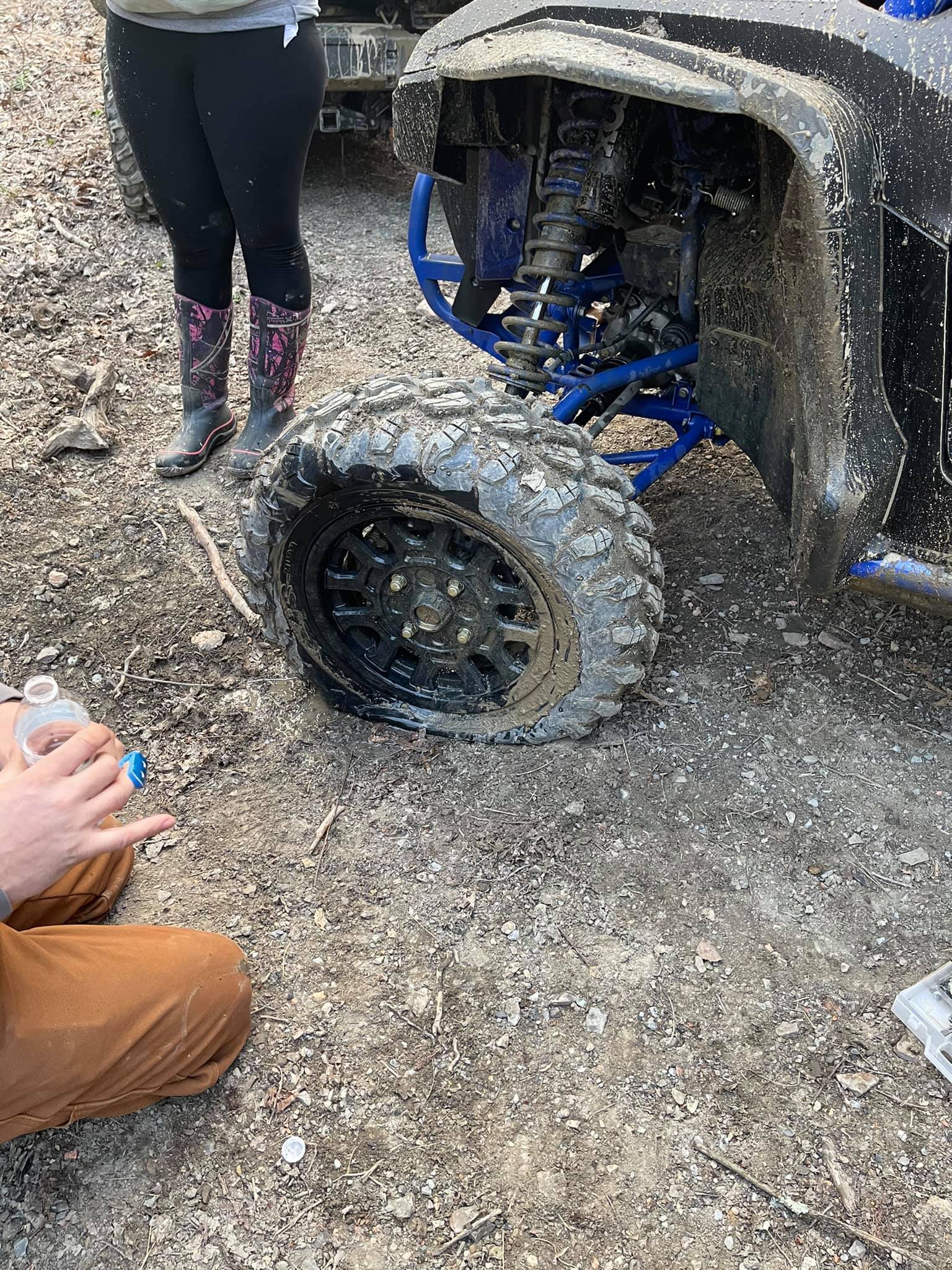 UTV with flat tire on trail