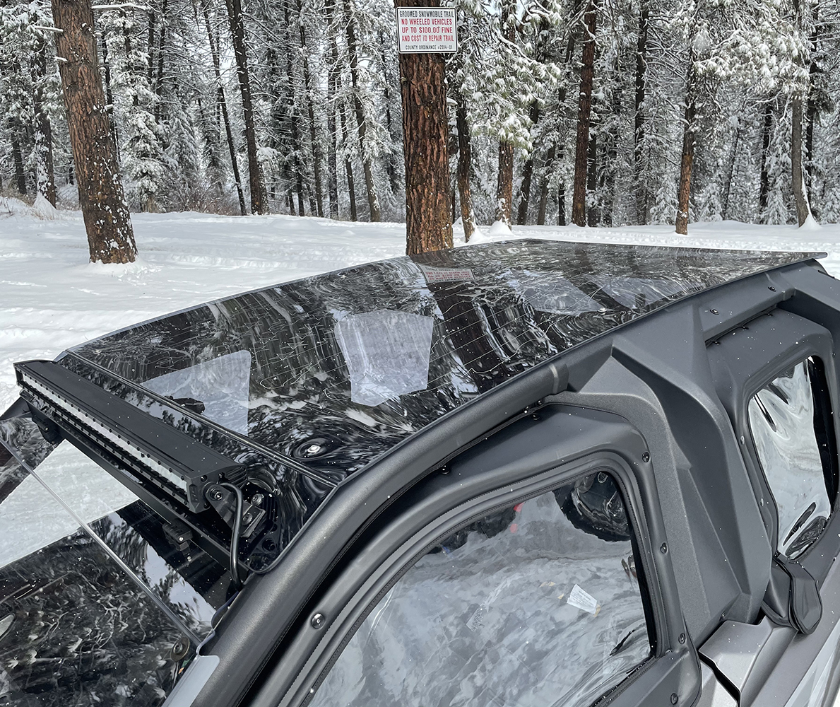UTV Roof Built for Snowy Conditions A durable UTV roof shields the vehicle’s cabin as it moves through a snow-covered trail. The sturdy top keeps snow and moisture off the riders while adding extra protection from the elements, making it ideal for winter adventures and cold-weather work.